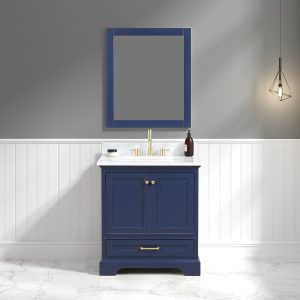 A bathroom with a Copenhagen 30 navy blue vanity and White Carrara marble top. A rectangular mirror hangs above, illuminated by a geometric pendant light. Gray walls with white wainscoting and a marble floor complete the look.