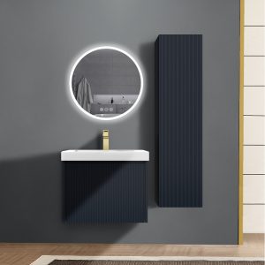 A modern bathroom features the Positano 24 inch Wall Mount Bathroom Vanity in Night Blue with a white sink and backlit circular mirror. A tall, matching cabinet is on a gray wall, complemented by a beige floor and partially visible white tiled section.