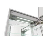 The Edge Royal 24 Inch Left Side LED Lighted Mirror Medicine Cabinet features built-in LED lighting, interior electrical outlets, and glass shelves. With one door open, the storage space and hinge mechanism inside are visible.