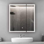 A modern bathroom features the Edge Royal 36 Inch LED Lighted Mirror Medicine Cabinet above a white sink and silver faucet. The mirror reflects a rainfall showerhead and dark-tiled shower, while a liquid soap dispenser sits on the counter.