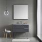 A modern bathroom features the Sofia 36 inch Wall Mount Bathroom Vanity in Matte Gray with a square mirror above its surface and dual spacious drawers. A round hanging light elegantly complements the minimalist design, while a small side table discreetly holds toiletries for convenience.