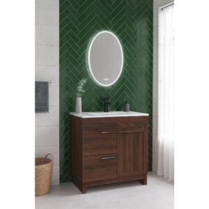 Bathroom featuring the Hanover 36 inch Bathroom Vanity With Sink, white countertop, oval LED mirror on a green herringbone-tiled wall, towel on the left, wicker basket on the floor, and sheer curtains over the window.