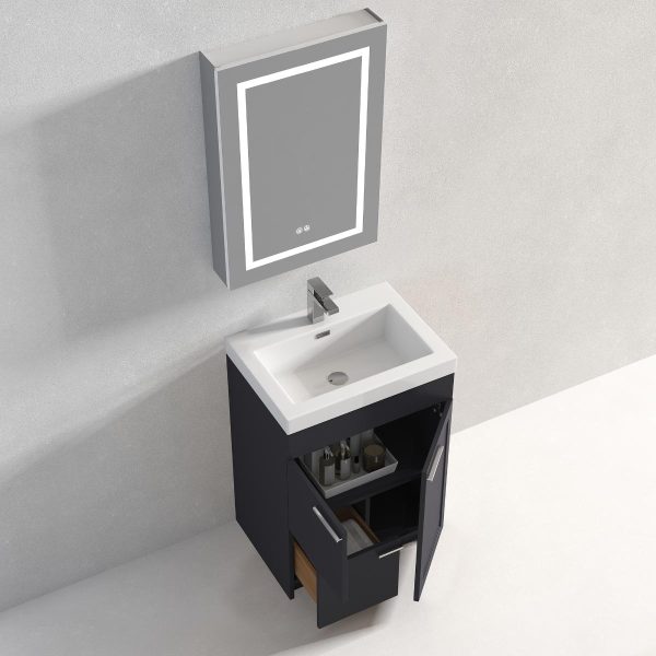 A modern bathroom setup features a wall-mounted rectangular mirror with integrated LED lights above the Hanover 24 inch Bathroom Vanity in Charcoal. A white sink with a silver faucet complements the open cabinet doors below, revealing stored toiletries.
