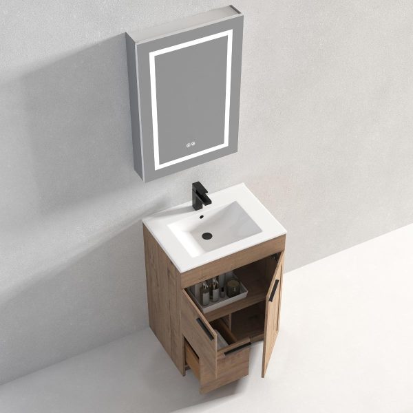 The Hanover 24 inch Bathroom Vanity With Sink - Classic Oak includes a lighted wall mirror above a wooden cabinet. Two doors and a drawer provide storage, while the white sink with a black faucet adds elegance.