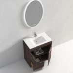 The Hanover 30 inch Bathroom Vanity With Sink features a white basin, open cabinet doors displaying toiletries, and an illuminated round mirror above, all against a light gray wall and floor.