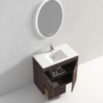 The Hanover 36 inch Bathroom Vanity With Sink features a white basin, dark wood cabinet, open drawers and doors for storage, and a round backlit mirror mounted on a light gray wall above.