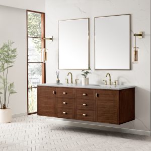 A modern bathroom features the Amberly 72" Double Vanity in Mid-Century Walnut with an Eternal Jasmine Pearl top, double sinks, brass fixtures, two large mirrors, wall sconces, a potted plant, and a tall window for natural light.