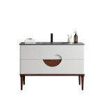 The Burano 48 inch Beige Freestanding Bathroom Vanity features a beige front, wooden legs, black countertop and faucet, plus stylish accessories like folded towels, a soap dispenser, and a toothbrush holder.