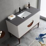 The Burano 48 inch Beige Freestanding Bathroom Vanity features a modern beige countertop, rectangular sink, black faucet, soap dispenser, and white towels. With two drawers and wooden legs, it complements any neutral bathroom decor.