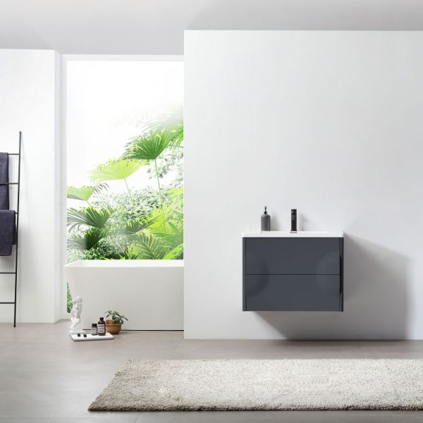 A minimalist bathroom showcases the Advento 30 inch Dark Gray Wall Mount Bathroom Vanity, paired with a black faucet and white countertop. A large window reveals lush greenery, while a gray rug and towels on a black ladder rack contribute to the bright and airy atmosphere.