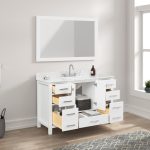 The Geneva 48 inch Bathroom Vanity in Matte White with a Carrara marble countertop includes a sink and silver faucet. Open drawers and cabinets reveal towels and toiletries, while a large mirror above reflects sunlight from a nearby window.