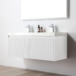 A modern Positano 48 inch Double Sink Wall Mount Bathroom Vanity in Matte White with sink is set against a plain white wall, topped with two faucets and a mirror, with soap and lotion on the counter above a light wood floor.