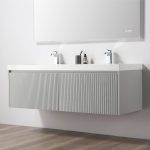 The Positano 60 inch Double Wall Mount Bathroom Vanity in Light Gray with an acrylic top features a ribbed front, two sinks with chrome faucets, and toiletries placed between them, set against a white wall beneath a mirror.