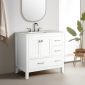 A modern bathroom features the Vanea 36 inch Bathroom Vanity in White with a white quartz top, sink, silver faucet, and metal-handled cabinets.