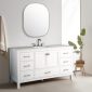 Modern bathroom with a Vanea 60 inch Single Bathroom Vanity in White with White Quartz Top, featuring six drawers, two cabinets, rectangular countertop and silver faucet, large oval mirror above, beige towel on the wall, and potted plant on wooden stand.