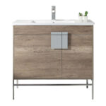 The Shawbridge 36 inch Modern Bathroom Vanity With Sink features a modern wood finish, sleek metal handle, sturdy metal legs, and a white sink. Two small potted plants accent the back right corner of the vanity.