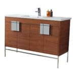 The Shawbridge 48 inch Modern Bathroom Vanity With Sink boasts a white countertop, chrome faucet, two square handles, and metal legs, topped with two bottles—ideal for a contemporary bathroom.
