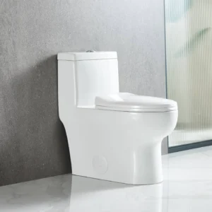 The Pureflow One Piece Toilet with a closed lid sits against a gray textured wall on a glossy white floor beside a frosted glass window.