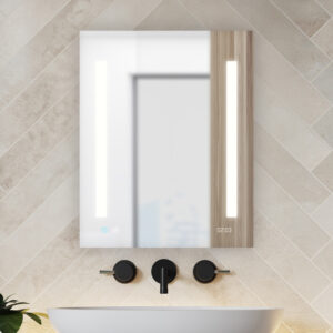 The Signature Royale 24"x36" Right Sided LED Lighted Mirror Medicine Cabinet features vertical LED lights, a digital clock in the lower right corner, and is paired with a minimalist black-faucet sink against beige-tiled walls.