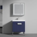 The Bari 30 inch Modern Bathroom Vanity With Sink has a navy blue cabinet, white countertop, and silver handles. Above, a wall-mounted mirror cabinet with an LED-lit border is centered on a light gray wall.