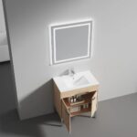 The Bari 30 inch Modern Bathroom Vanity With Sink has a light wood cabinet with open doors showing toiletries, and a large illuminated rectangular mirror mounted above on a plain gray wall.