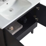 A Venezian 30 inch Bathroom Vanity With Sink in black is shown with its cabinet door open, displaying a folded gray towel, a soap bar, and small toiletry bottles arranged on the shelf below the white sink.