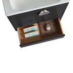 Opening the drawer of the Venezian 24 inch Bathroom Vanity With Sink, you’ll find two rectangular boxes and a square perfume bottle neatly placed on a brown mat beneath the white sink.