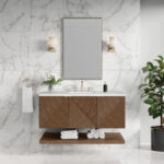 Modern bathroom with white marble walls, a rectangular mirror, wall-mounted lights, and a Marcello 48 inch Wall Mounted Vanity in Chestnut featuring geometric doors, a white sink, and a plant on the right. Towels and toiletries are neatly arranged.