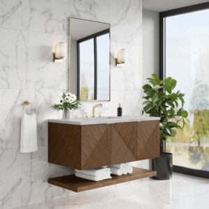 Modern bathroom with a floating wooden vanity, geometric pattern, and gold fixtures. Marble walls, a large mirror, wall sconces, a potted plant, and folded towels complete the decor. Large window lets in natural light.