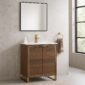 A modern bathroom showcases the Opulence 30 inch Modern Bathroom Vanity with a gold faucet, square mirror, and beige marble walls. A towel ring with a tan towel hangs by the window, and a soap dispenser accentuates the vanity.