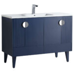 The Venezian 48 inch Bathroom Vanity showcases a modern navy blue finish, two cabinet doors with vertical grooves, round silver handles, angled legs, a white countertop, integrated sink, and a chrome faucet.