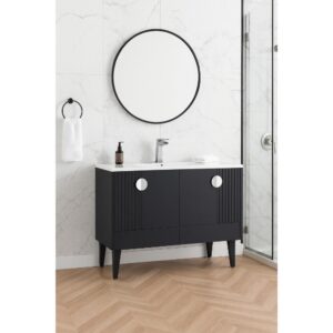The Venezian 48 inch Bathroom Vanity with a black cabinet, white countertop, and chrome faucet sits below a round mirror on a white marble wall. A towel ring with a white towel and glass shower enclosure are also visible.