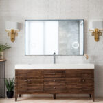 Modern bathroom with a Linear 72 inch Single Bathroom Vanity Cabinet, rectangular mirror, white sink, gold wall sconces, white brick walls, and potted plants on the floor and a small table.