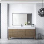 Modern bathroom with a Linear 72 inch Single Bathroom Vanity Cabinet, rectangular mirror, and white subway tile walls. A black spherical pendant light hangs overhead. Large windows and plants bring in natural light and greenery.