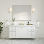 A minimalist bathroom features the Chicago 60 inch Single Bathroom Vanity Cabinet with gold handles, a rectangular mirror, and two wall sconces. A small plant and toiletries decorate the countertop, while marble tiles cover the lower walls and floor for an elegant touch.