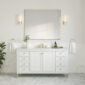 A minimalist bathroom features the Chicago 60 inch Single Bathroom Vanity Cabinet with gold handles, a rectangular mirror, and two wall sconces. A small plant and toiletries decorate the countertop, while marble tiles cover the lower walls and floor for an elegant touch.