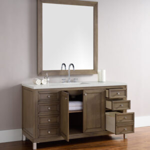 The Chicago 60 inch Single Bathroom Vanity Cabinet includes a wooden-framed mirror, spacious design with multiple drawers and cabinet, a sink with dual faucets, and a countertop adorned with a toilet paper roll and jar.