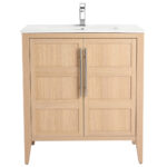 The Leafside 30 Inch Bathroom Vanity features a light oak finish with two cabinet doors and vertical metallic handles. It includes a white sink paired with a modern faucet, all in a wooden design.