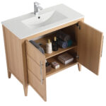 Introducing the Leafside 36 Inch Bathroom Vanity With Sink, featuring open wooden cabinet doors revealing neatly arranged toiletries and towels. The bright white sink is complemented by a sleek chrome faucet, while the interior holds rolled towels, bottles, a box, and a jar for your convenience.