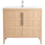 The Leafside 36 Inch Bathroom Vanity With Sink features a natural finish, double paneled doors, sleek vertical handles, a pristine white countertop, and a modern silver faucet, blending style and function for your bathroom oasis.