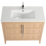 The Leafside 36 Inch Bathroom Vanity With Sink features a light wood cabinet with two doors, sleek metal handles, a white rectangular sink basin, and a modern chrome faucet, perfect for adding minimalist elegance to any contemporary bathroom.