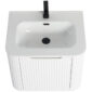 The Caskvalley 24 Inch Wall Mounted Bathroom Vanity features a ribbed cabinet with a white rectangular basin, a sleek black faucet, central drain, and overflow hole, offering a modern design that contrasts beautifully with the smooth sink surface.