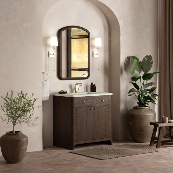 The elegant bathroom features a Gracyn 36 inch Bathroom Vanity with a dark wood cabinet and a large mirror. Two wall-mounted lights flank the mirror, while potted plants and a small stool introduce natural elements into the neutral space.