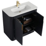 The Shireplace 36 Inch Bathroom Vanity With Sink flaunts a black design with a sleek white countertop and a gold faucet. Its open cabinet doors display towels and essentials, combining modern elegance with practical storage.