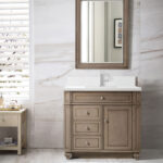 A bathroom with a wooden vanity, white countertop, rectangular mirror, and single-handle faucet. Marble-patterned walls and floors, white shutters, a side table, and a small white rug complete the space.