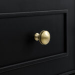 Close-up of a Lorelai 36-inch Bathroom Vanity Cabinet drawer in black, showcasing a gold round metallic knob and subtly beveled frame for an elegant design.