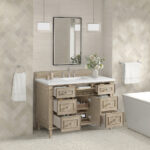 A modern bathroom with light beige herringbone tile walls, the Lorelai 48 inch Single Bathroom Vanity Cabinet featuring seven open drawers and a white countertop, a rectangular mirror, two pendant lights, towels on both sides, and a vase of flowers.