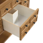 Open a wooden drawer with black knobs to reveal an empty interior and smaller compartment. It belongs to the Malibu 48 inch Bathroom Vanity Cabinet in Amber Birch, featuring multiple identical drawers for organized storage.
