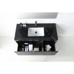 The Matera 48 Inch Wall Mount Bathroom Vanity With Countertop features a sleek rectangular white sink, minimalist faucet, and open drawers neatly organized with towels and toiletries, viewed from above.
