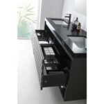 The Matera 60 Inch Wall Mount Double Bathroom Vanity With Countertop in black features two sinks, open drawers stocked with towels and toiletries, and is set against a frosted window with leafy patterns in the background.